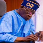Tinubu Signs New Electoral Law as National Assembly Erupts Over Result Transmission